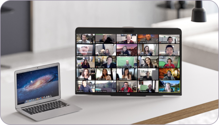 Small laptop with DTEN ME Screen in a large Zoom meeting on top of a white desk