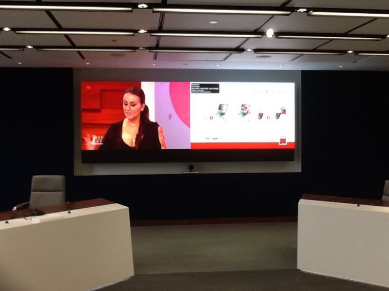 Large screen image set behind 2 presentation desks