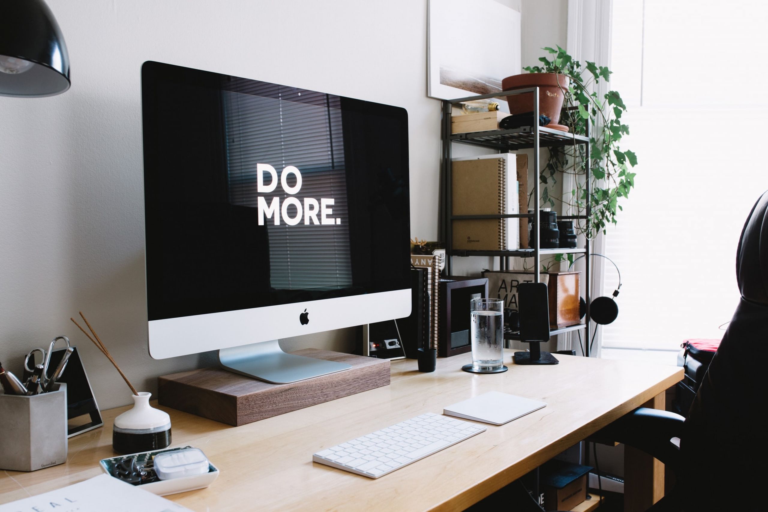 Home Office with Apple iMac 'DO MORE' on screen - Photo by Carl Heyerdahl on Unsplash