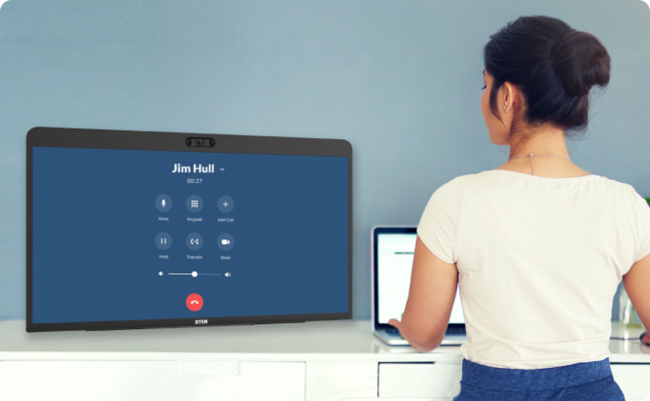 A young woman with a white top on making a telephone call on a DTEN ME Screen