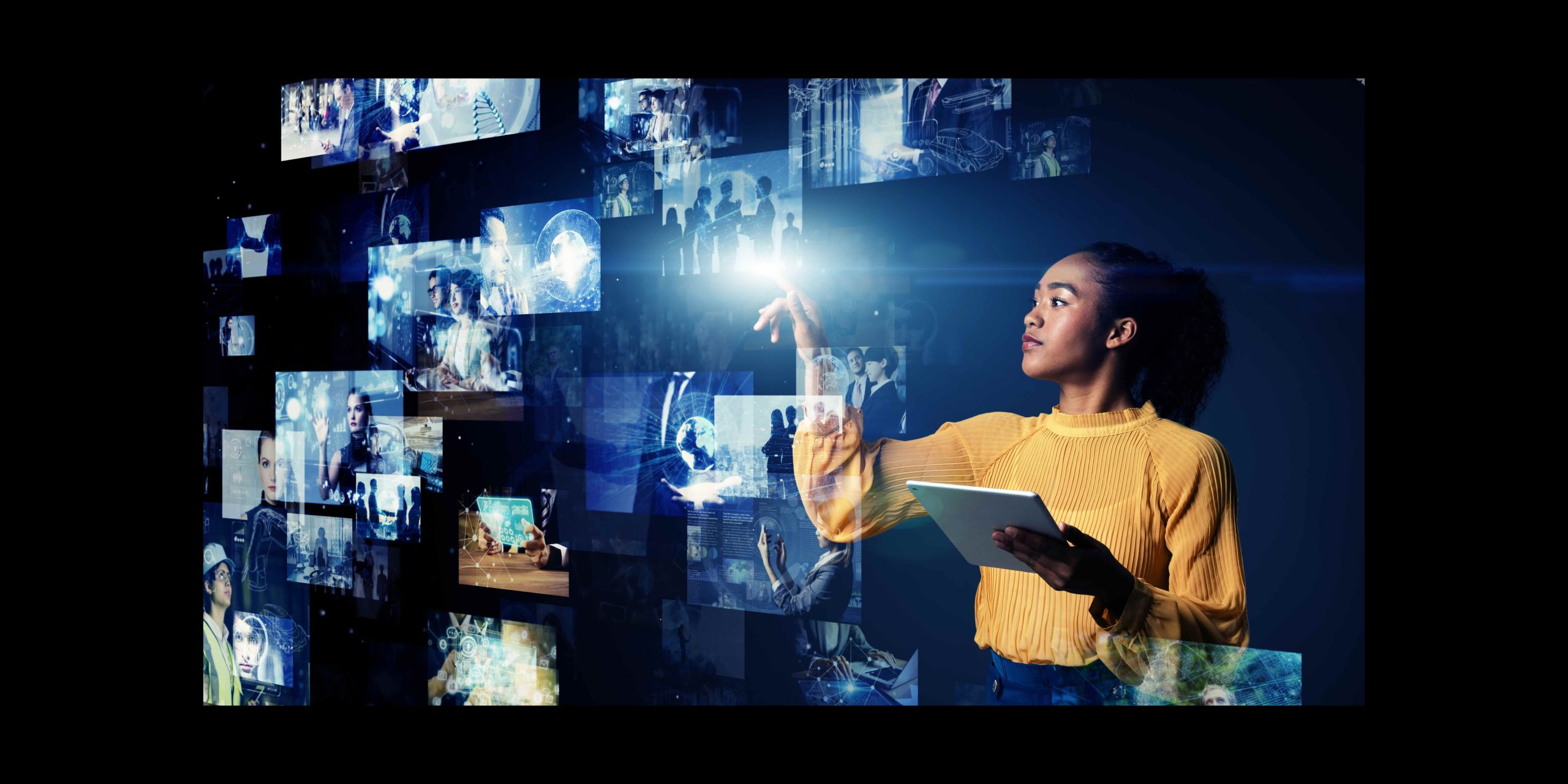 Young woman in yellow jumper interacting with a set of virtual computer displays floating in the air in front of her